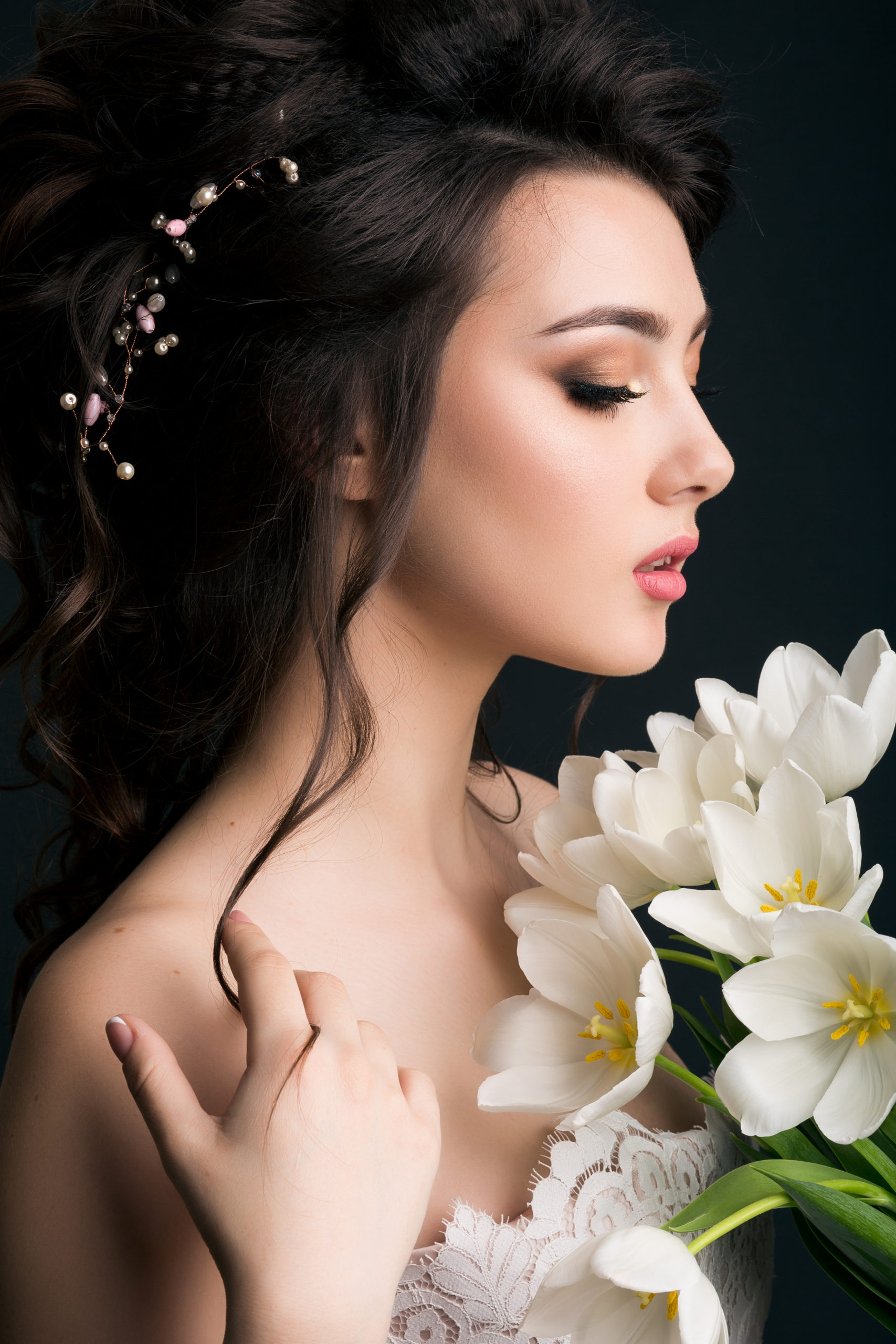 young beautiful stylish woman, bride, bridal fashion, spring trend, flowers, tulips, hairstyle, beauty make-up, white dress, tenderness, innocence, dark background